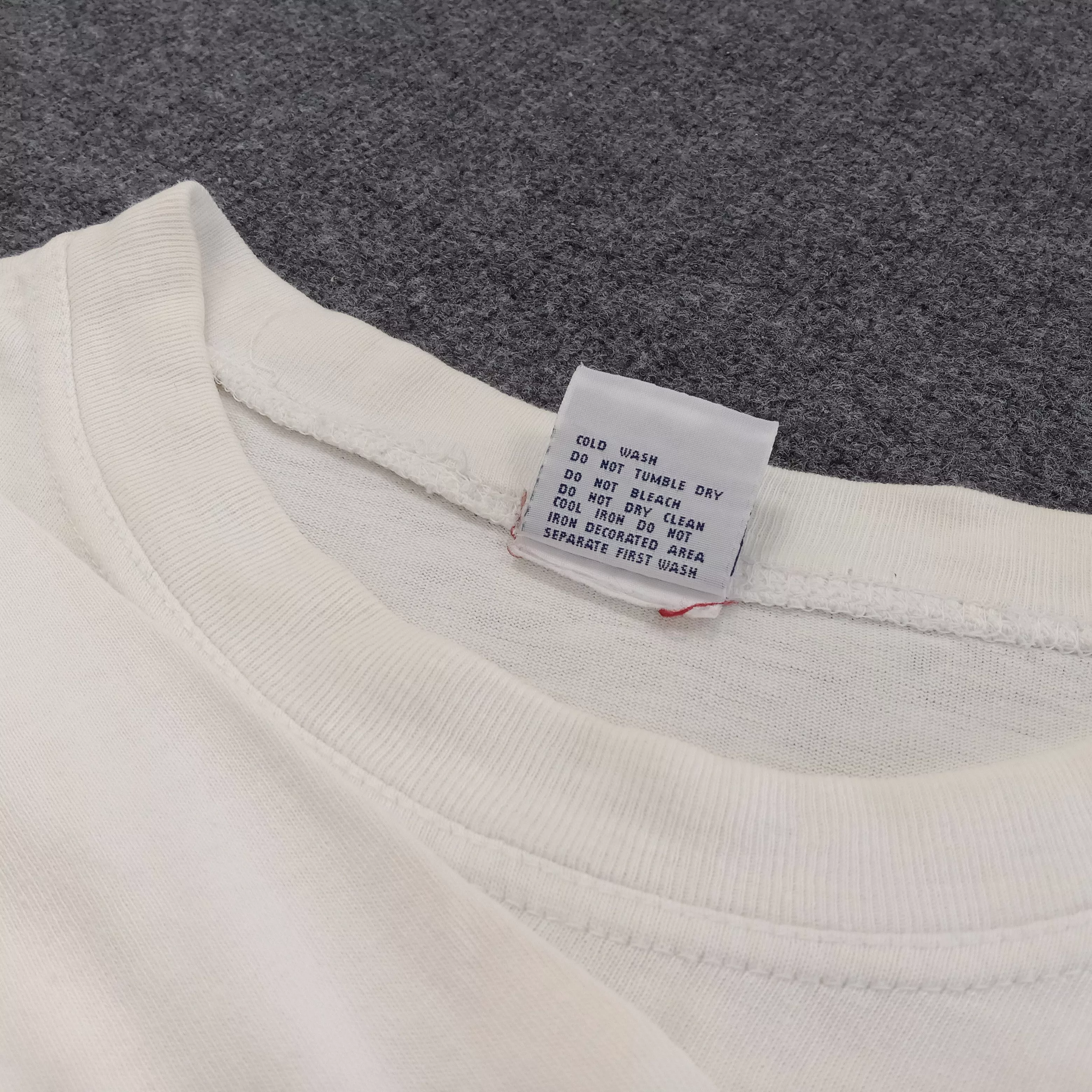 Universal Studios Short Sleeve T Shirts Universal Studios × Vintage James Bond 007 Tomorrow Never Dies Movie Tshirt White