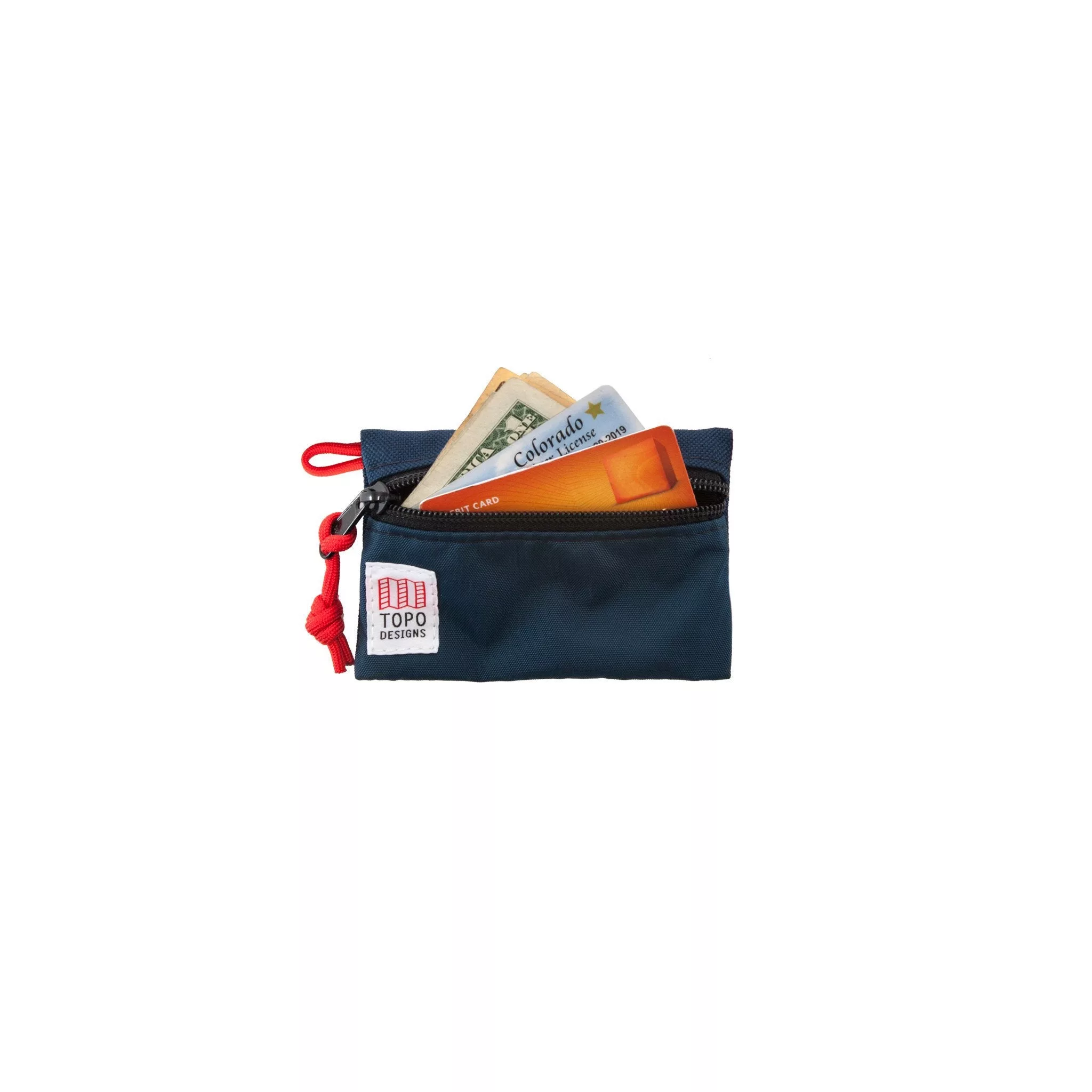 Detail shot of Topo Designs Accessory bags, organizer pouches for travel, showing money and credit cards inside the micro navy blue bag.