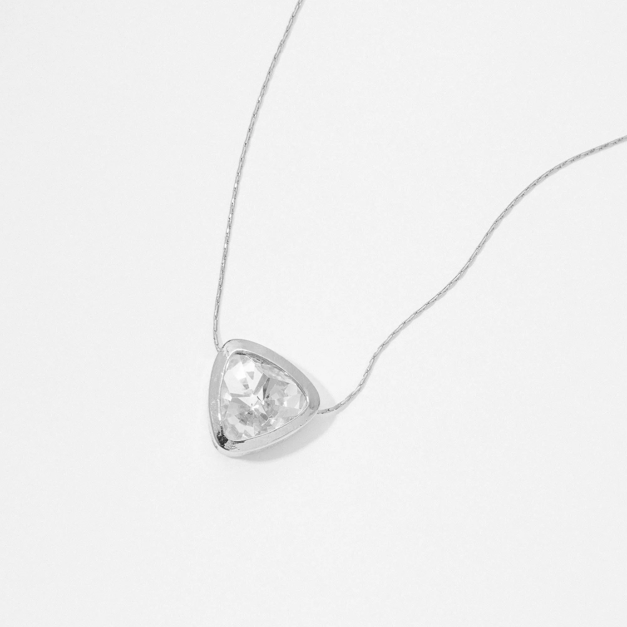 &LIVY Let The Light In Pendant Necklace in finely finished silver featuring large clear crystal pendant in heart shape with silver bezel setting on delicate silver chain