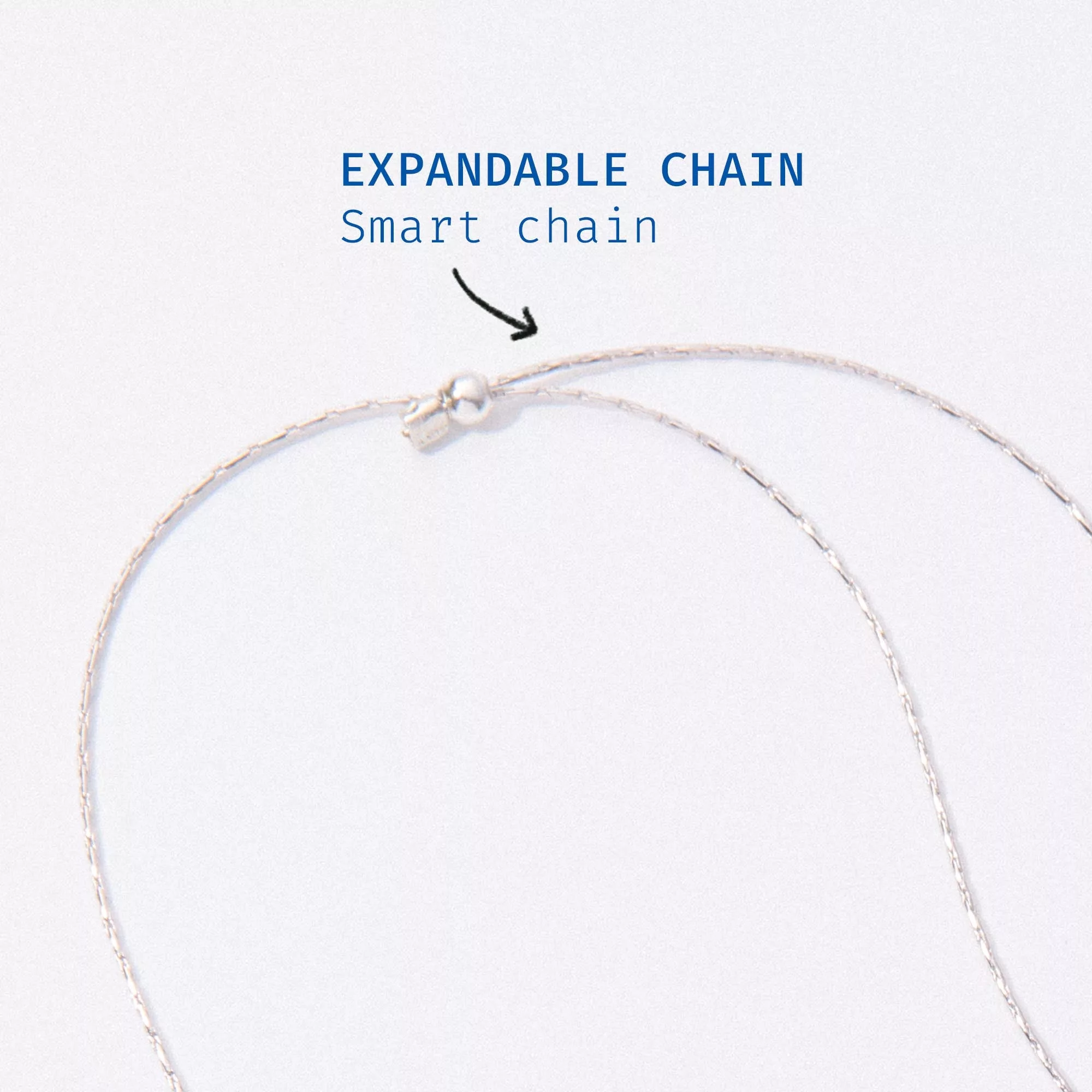 Expandable chain necklace on a light gray background