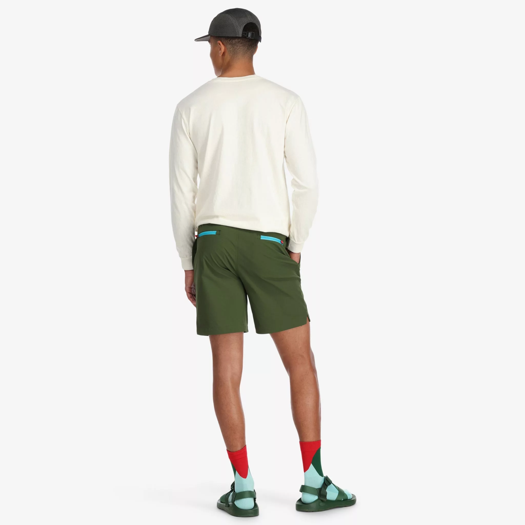Back of model wearing Topo Designs Men's Global lightweight quick dry travel Shorts in Olive green.