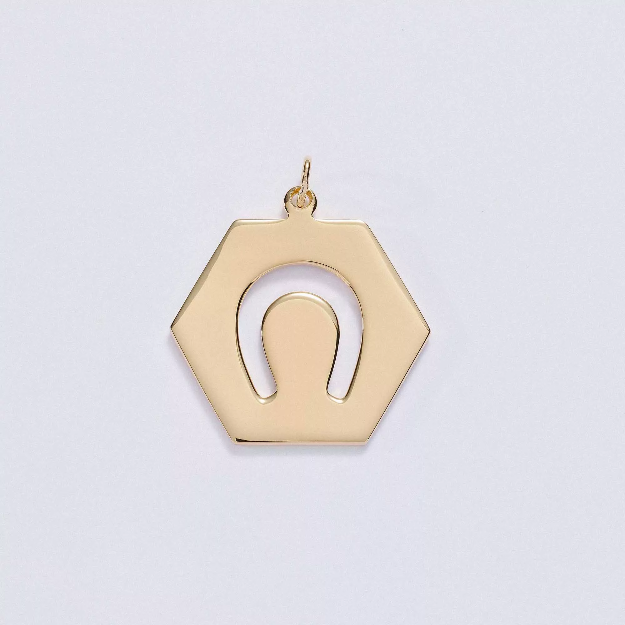&LIVY Luck in Motion Charm in gold hexagonal pendant with horseshoe cutout design